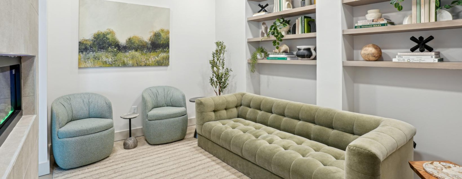 a living room with green couches