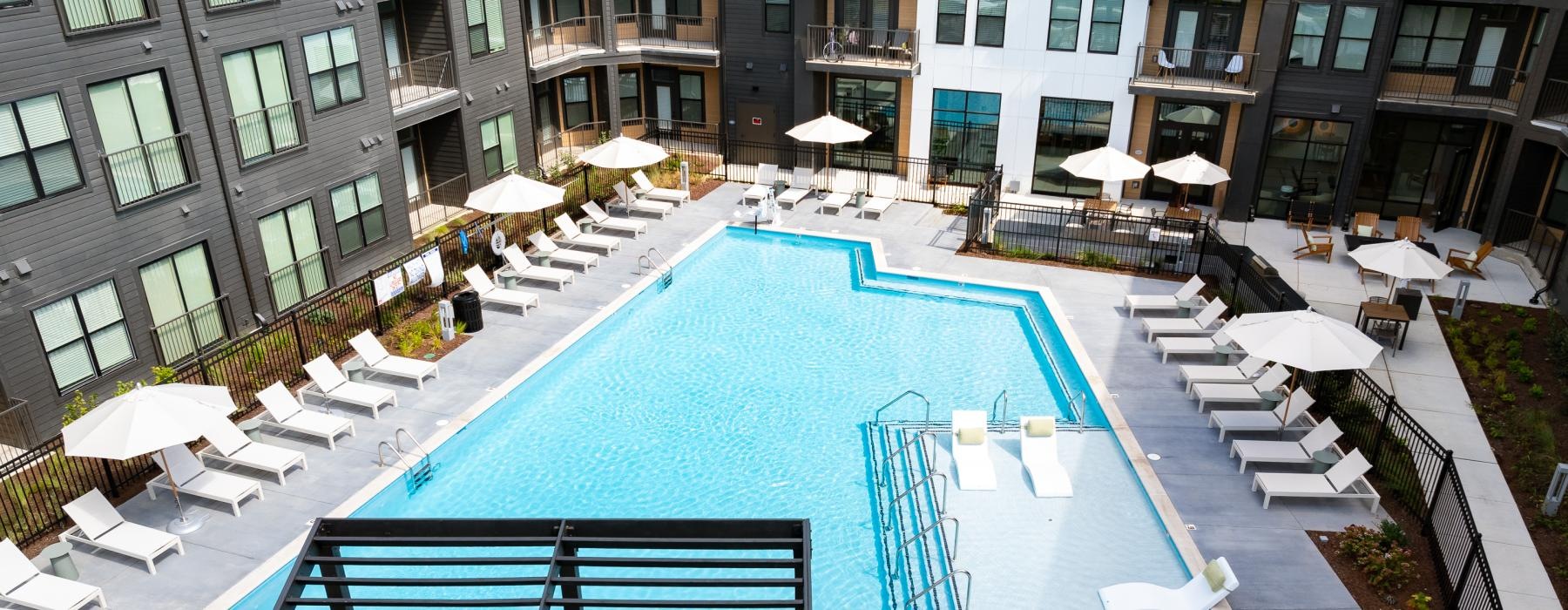 a pool with umbrellas and chairs